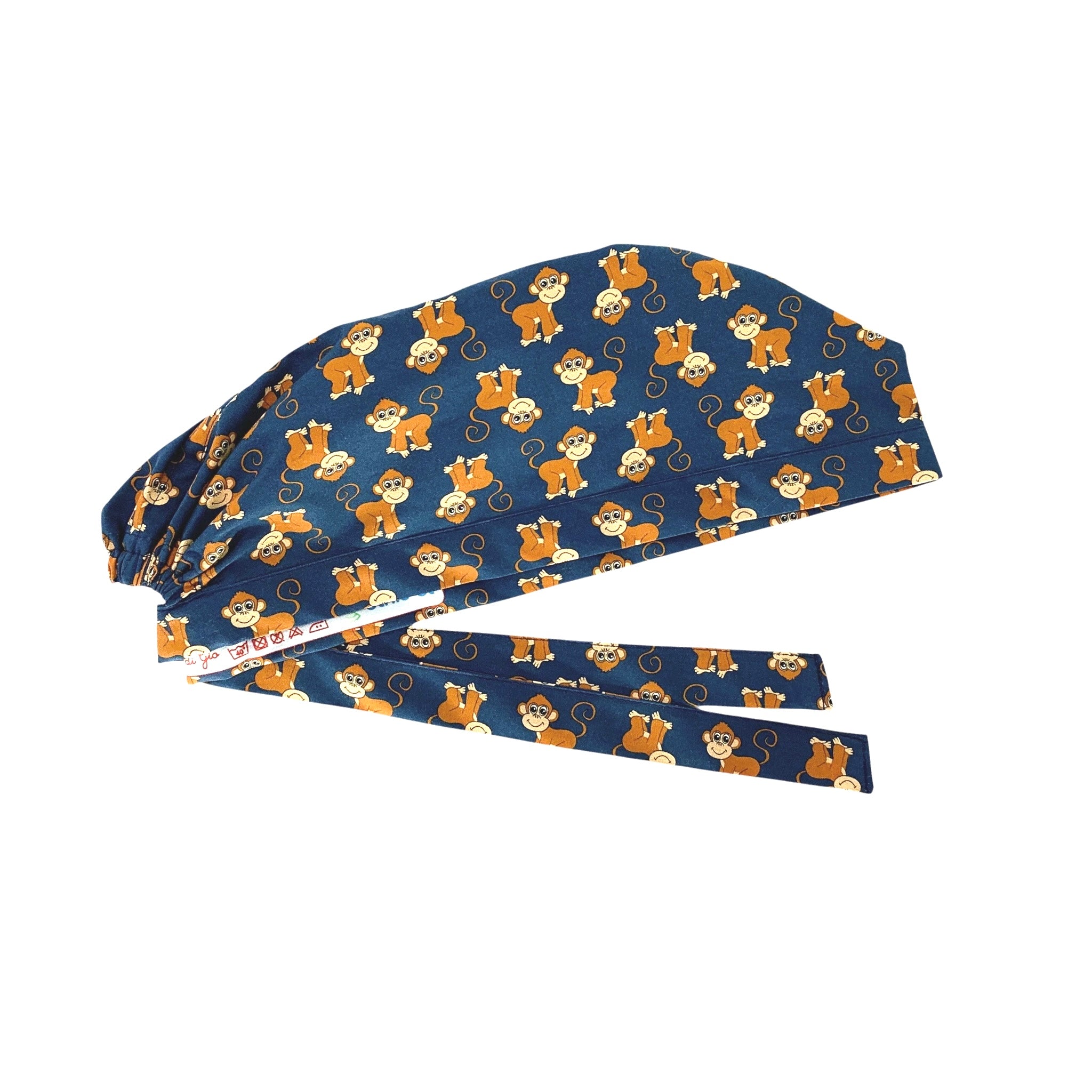Cuffietta chirurgica con simpatiche scimmiette marroni, sorridenti e con la coda lunga arricciata, alternate a testa in giù o diritte; sfondo blu