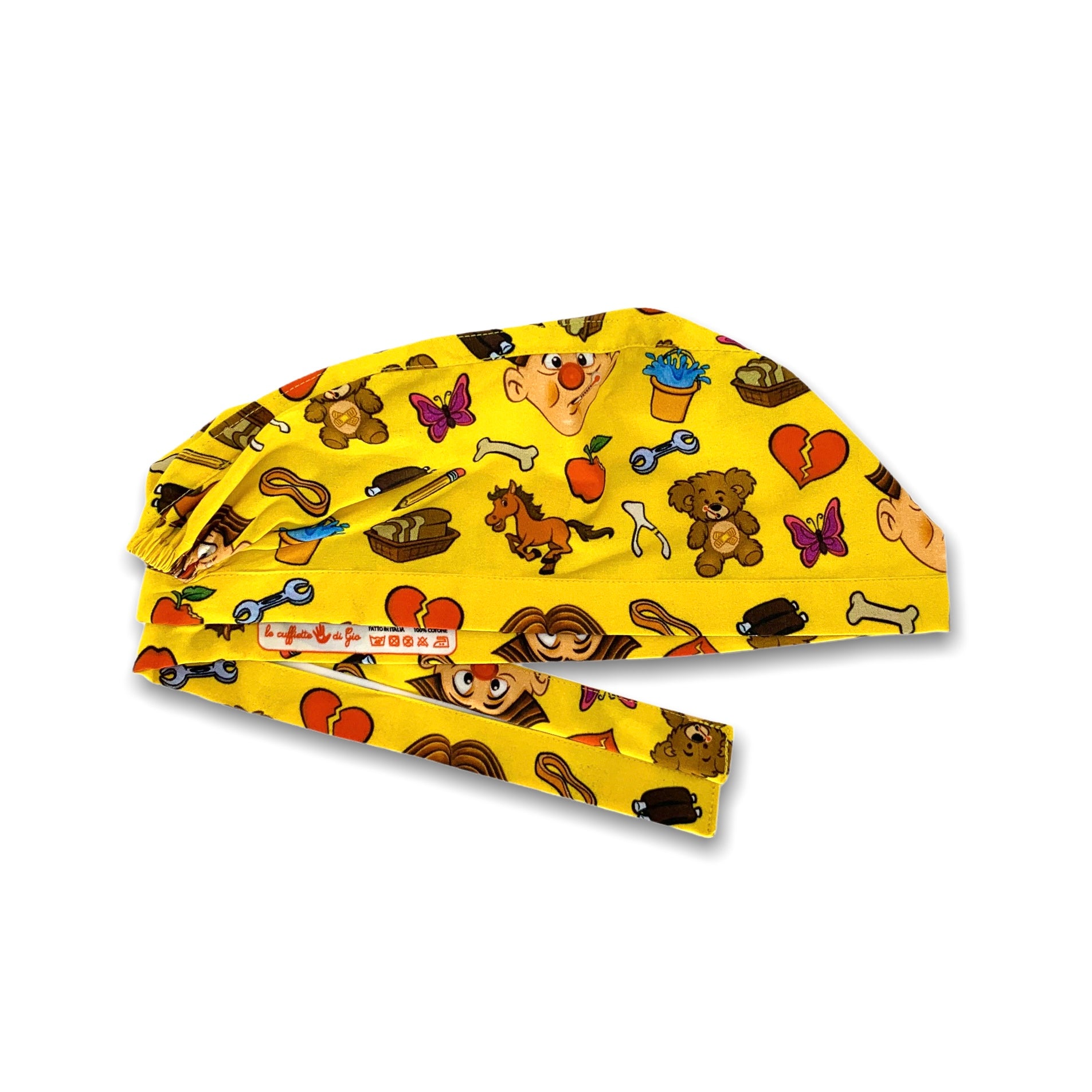 Cuffietta chirurgica gialla su cui ci sono sparsi i pezzi colorati del famoso gioco di società allegro chirurgo