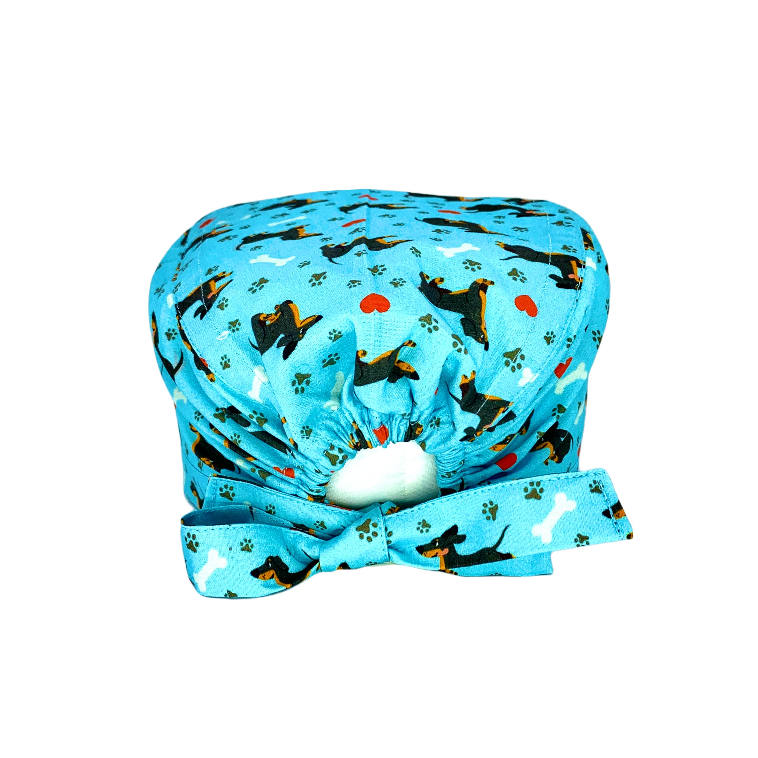 Un simpatico bassotto corre felice fra impronte di zampette, ossi da sgranocchiare e cuoricini in una combinazione di colori vincente!