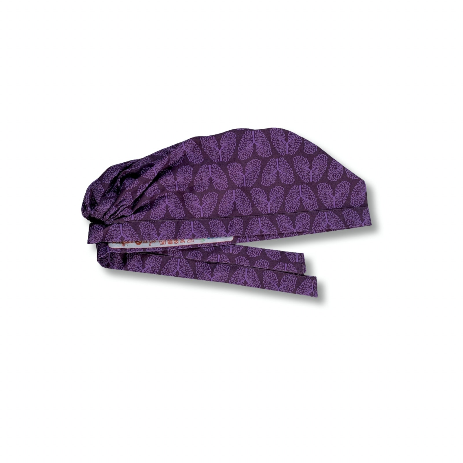Un pattern elegante per questa cuffietta chirurgica che riproduce la struttura dell'albero bronchiale trasformandolo in piccole foglioline come se fosse un vero albero, tono su tono viola. Un richiamo alla salute dei nostri polmoni e alla natura.