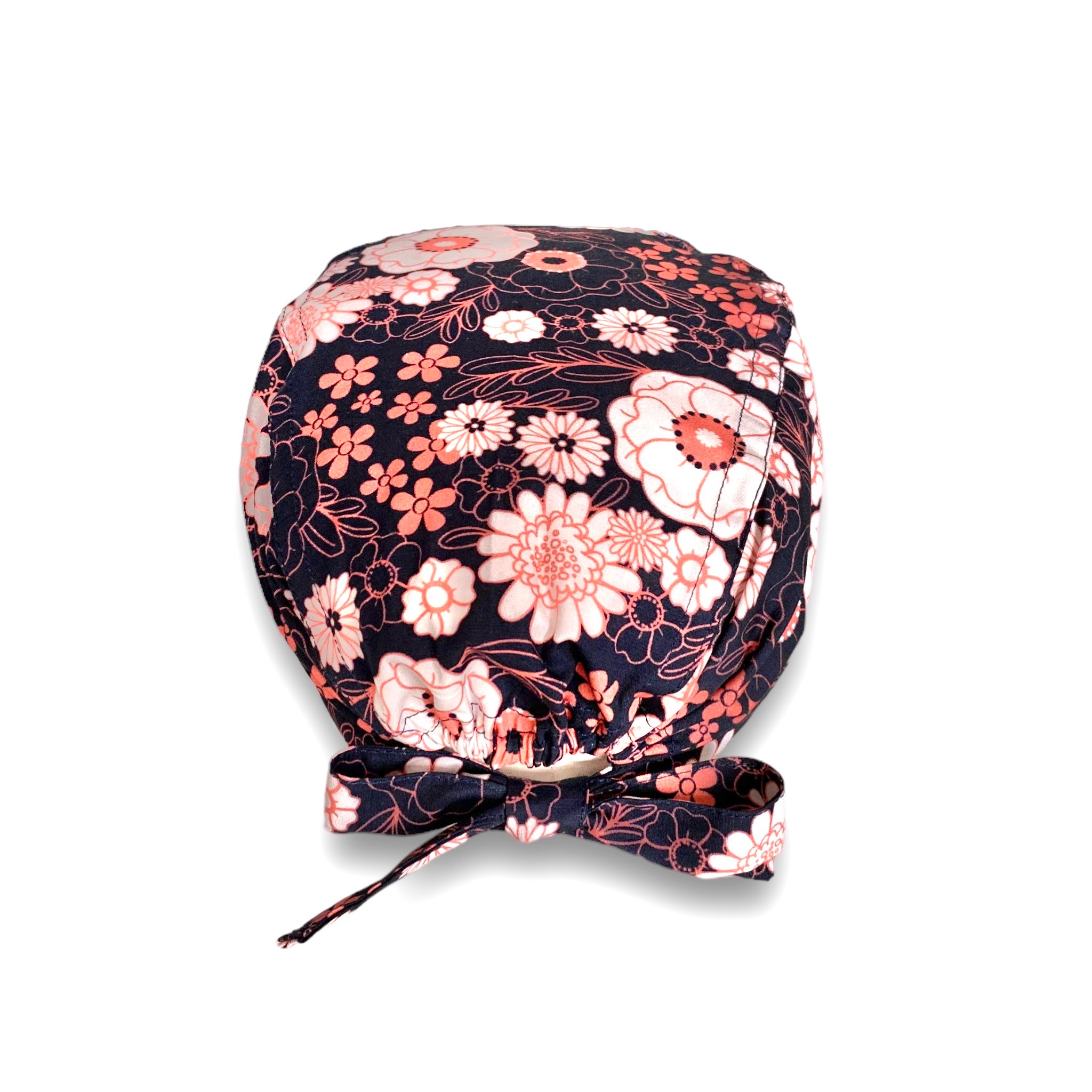 Una fantasia floreale con due soli colori: bianco latte e salmone. Fiori grandi e piccoli, margherite e peonie, si alternano a fogliame disegnato solo nel contorno per dare leggerezza e risaltare il contrasto con lo sfondo blu scuro