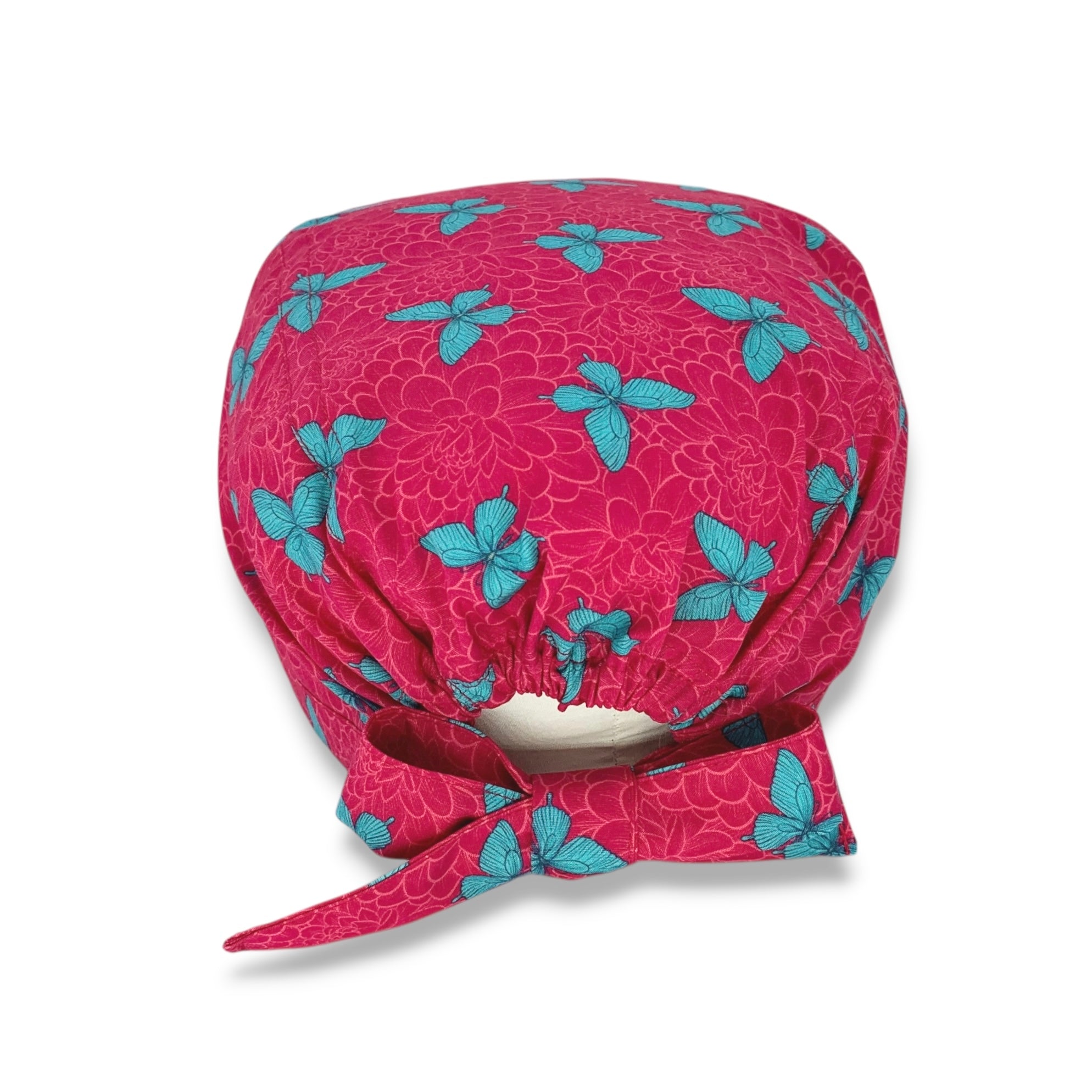 Un'elegantissima fantasia con dalie sfumate tono su tono e delicate farfalle a contrasto; farfalle verde menta su sfondo magenta