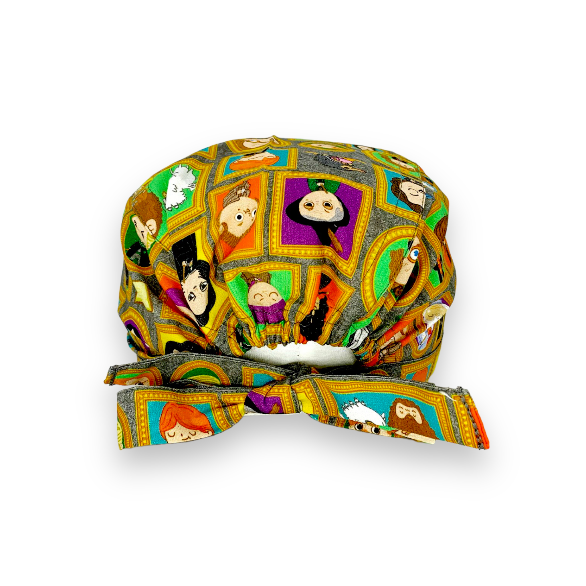 Cuffietta chirurgica con vivaci ritratti dei personaggi della saga sulla scuola di magia più misteriosa della letteratura, tutti incorniciati da cornici dorate e appesi a uno sfondo con carta da parati floreale grigia tono su tono