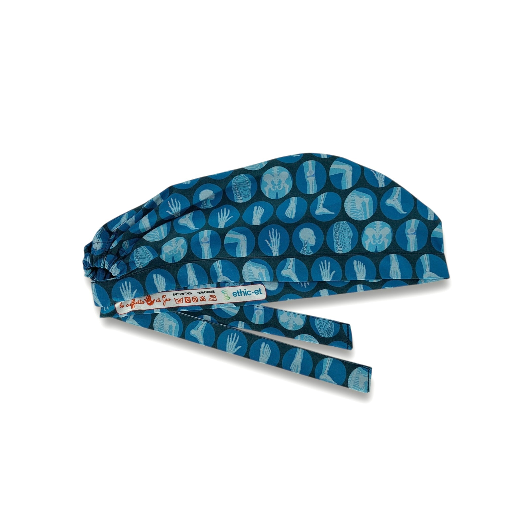 Cuffietta per medico blu con bolli azzurri in cui sono rappresentate le principali articolazioni e ossa del corpo umano in un azzurro ancora più chiaro. Ovviamente è una cuffietta ideale per un ortopedico