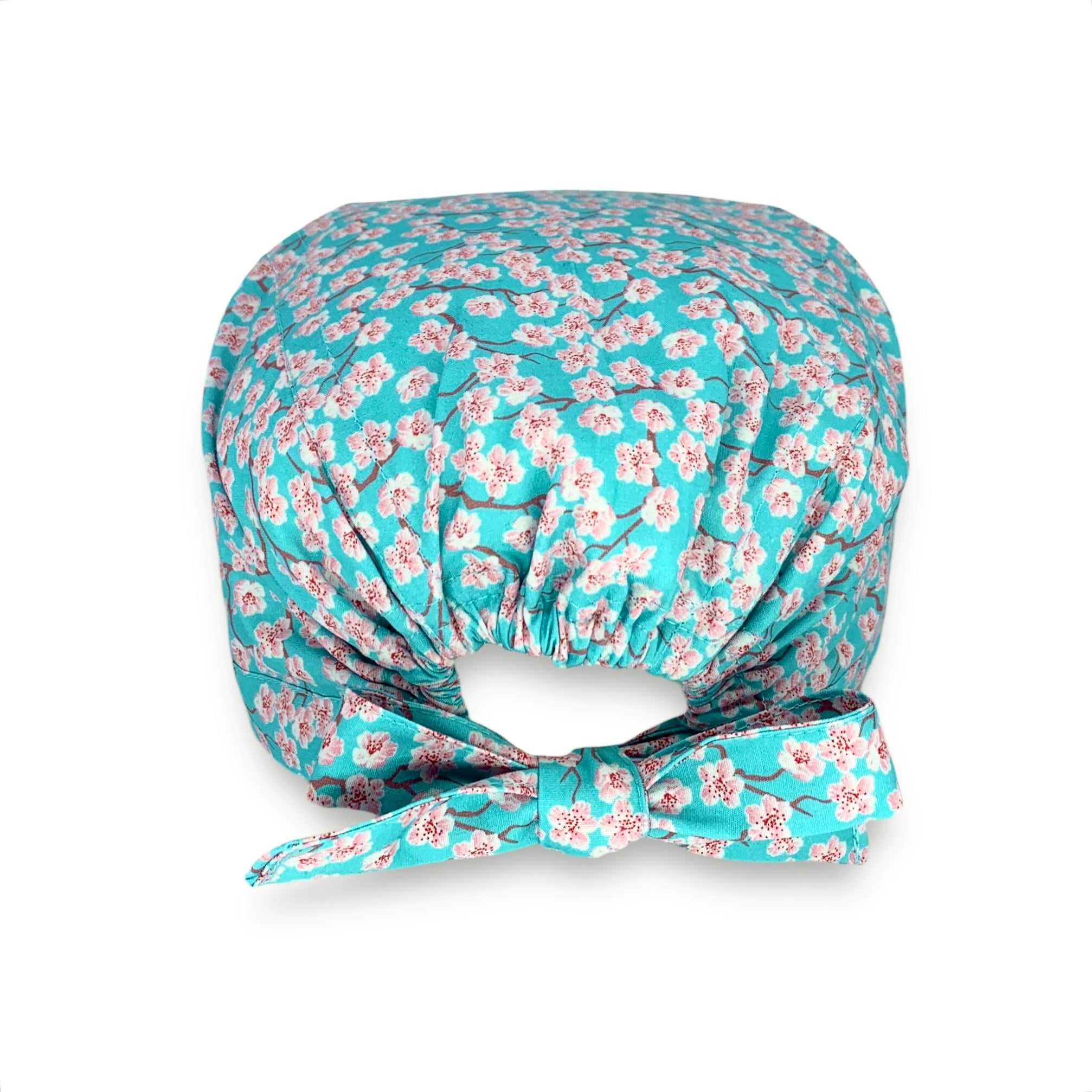 Cuffietta chirurgica con piccoli fiori di ciliegio rosa su base bordeaux