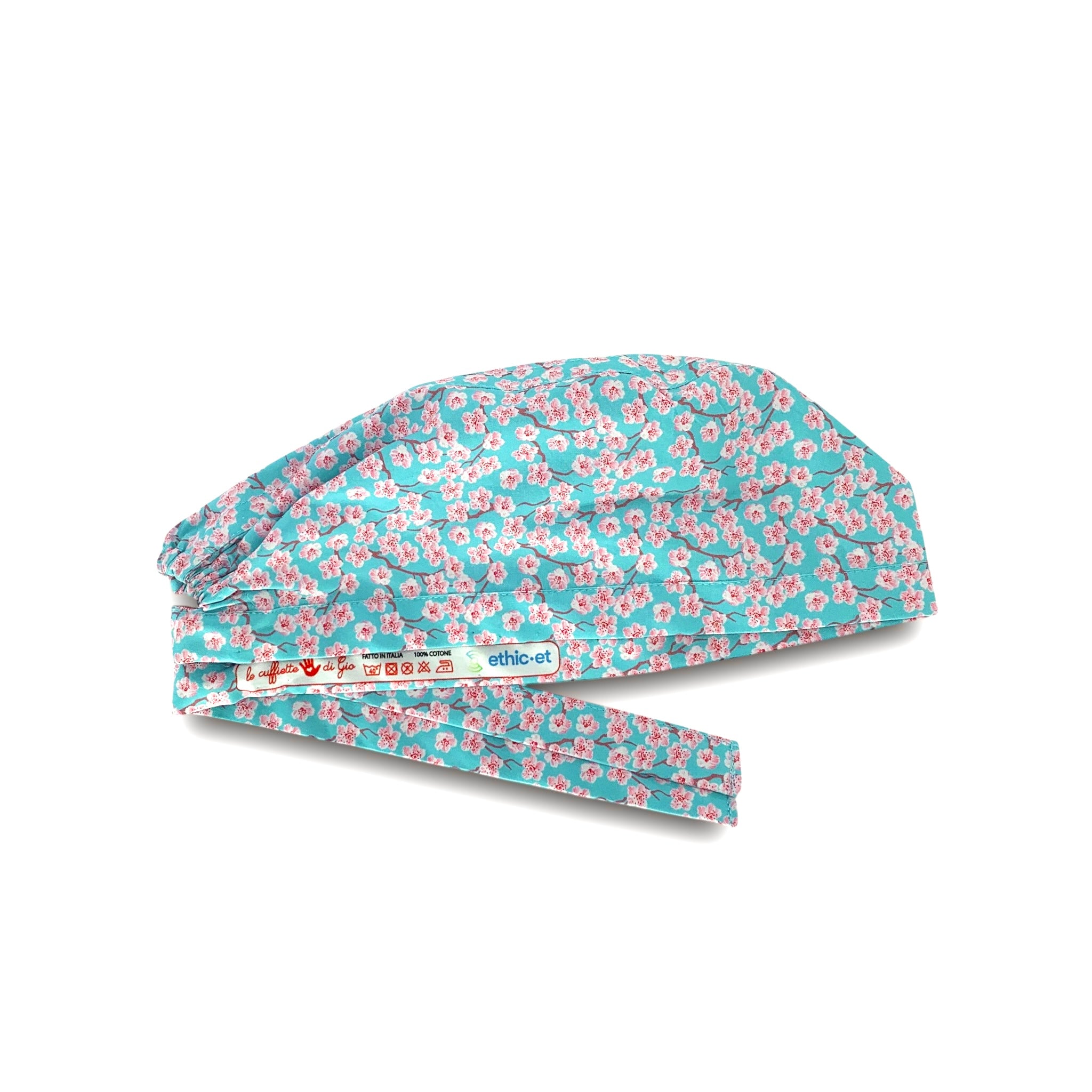 Cuffietta chirurgica con piccoli fiori di ciliegio rosa su base bordeaux