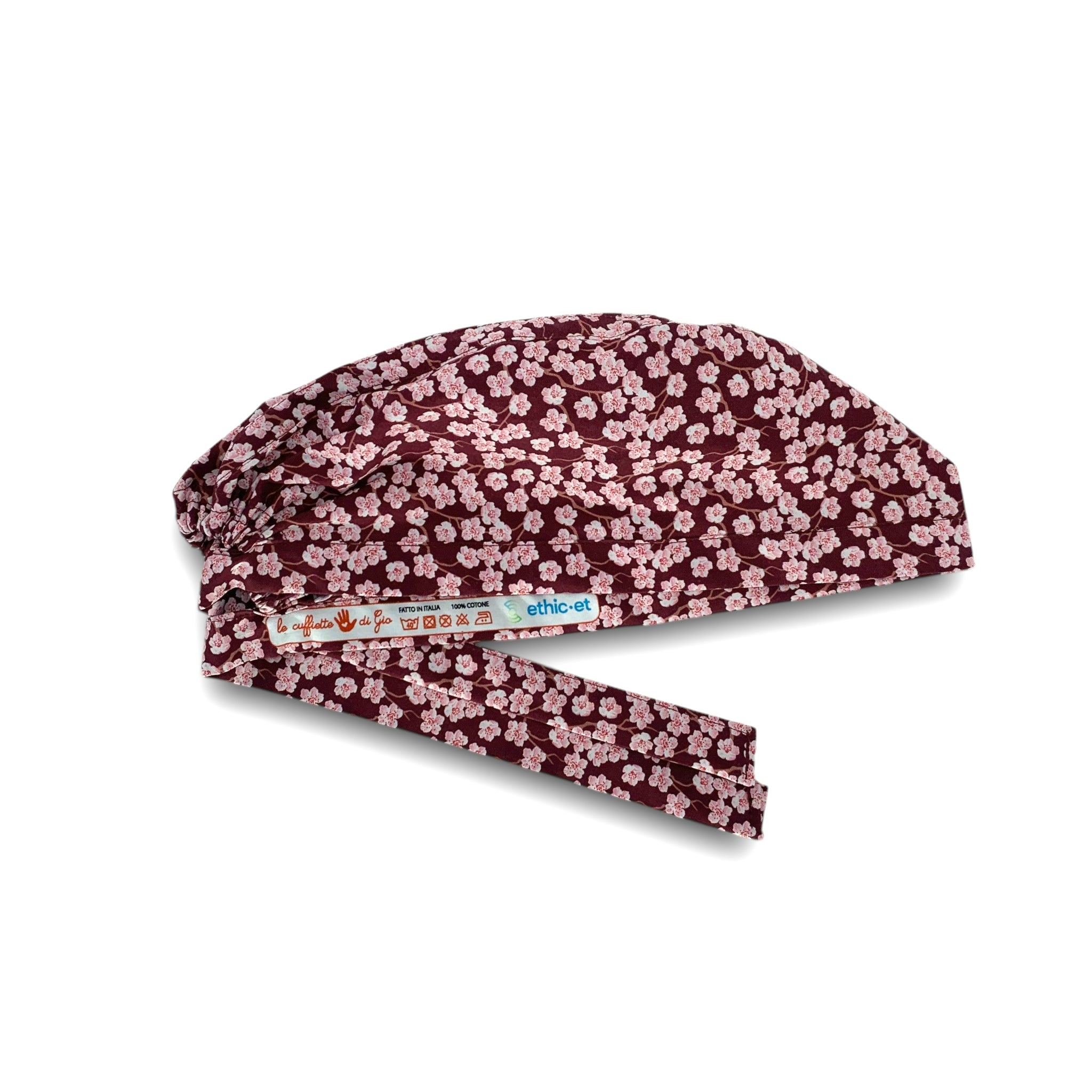 Cuffietta chirurgica con piccoli fiori di ciliegio rosa su base bordeaux