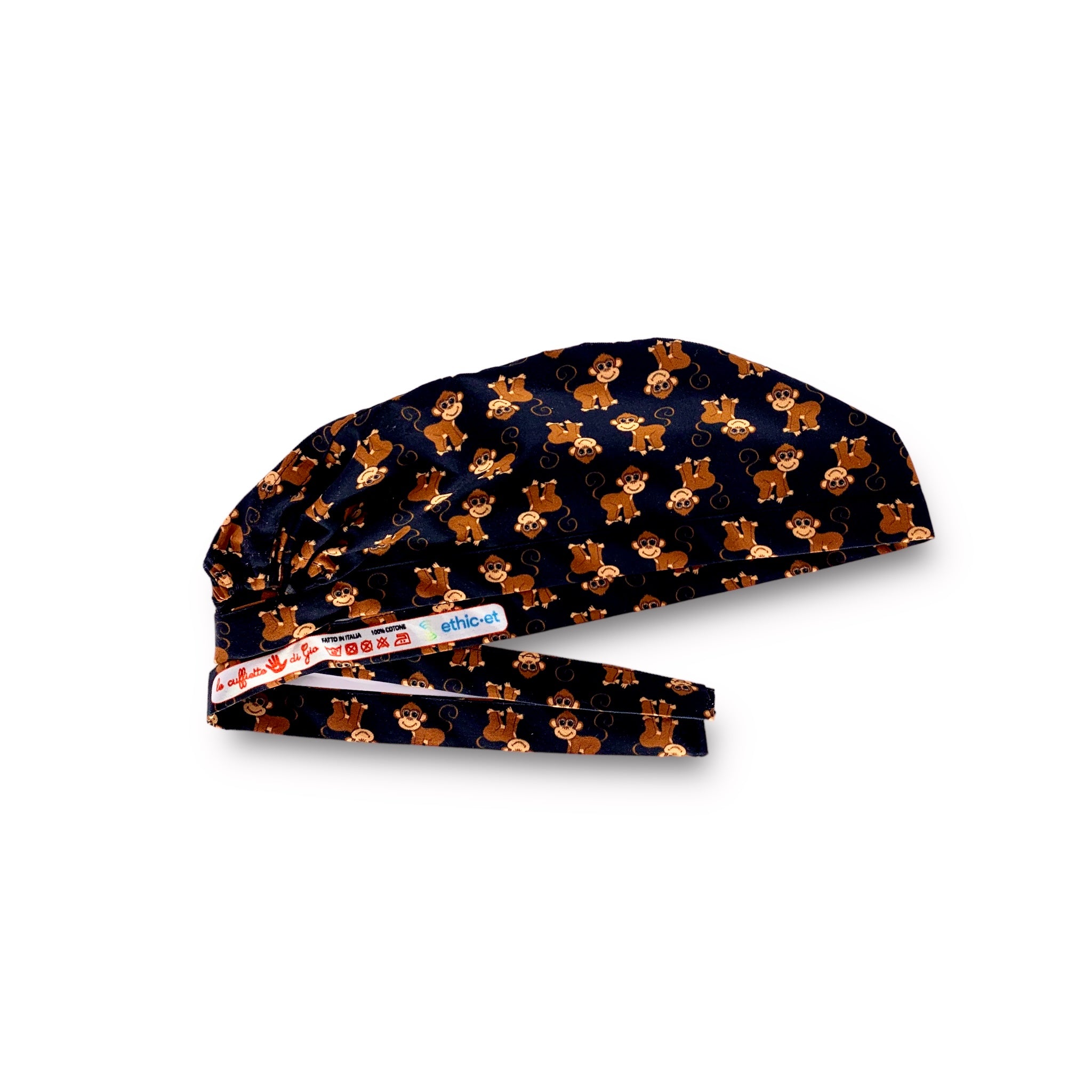 Cuffietta chirurgica con simpatiche scimmiette marroni, sorridenti e con la coda lunga arricciata, alternate a testa in giù o diritte; sfondo azzurro intenso
