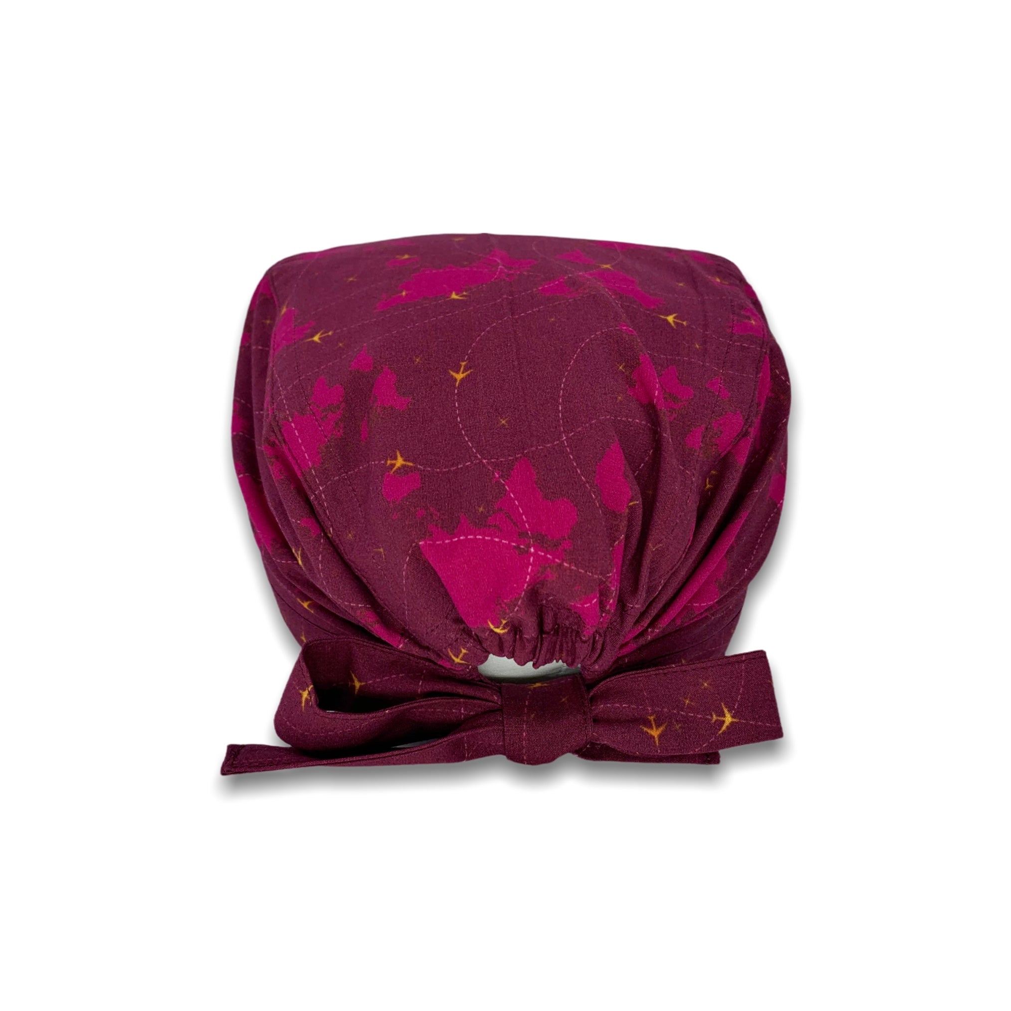 Cuffietta chirurgica con mappamondo e piccoli aerei gialli che tracciano delle linee tratteggiate, sfondo bordeaux