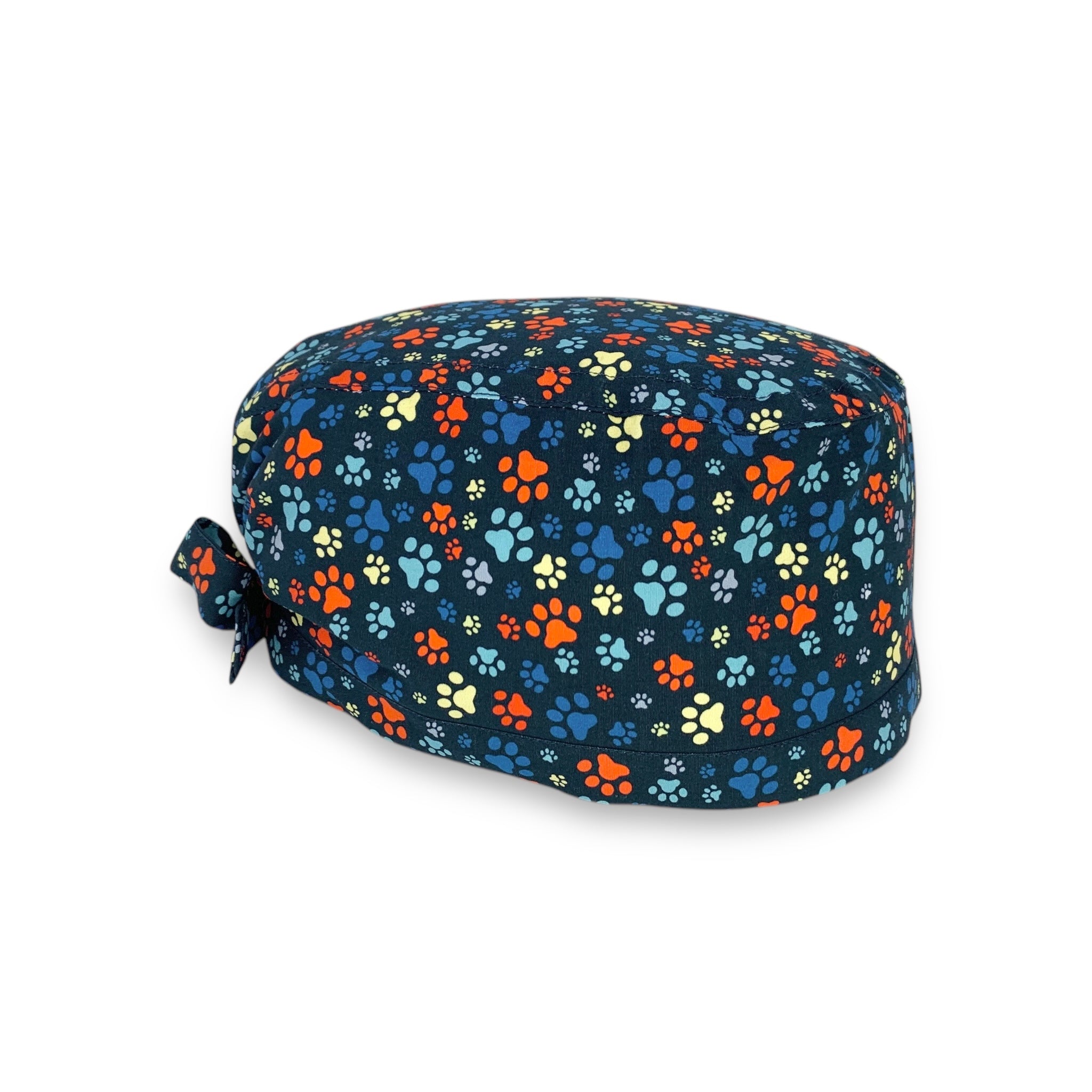 L'orma di una zampa di cane o gatto declinata in varie dimensioni e colori su base blu delinea un pattern semplice, vivace ed elegante al tempo stesso.