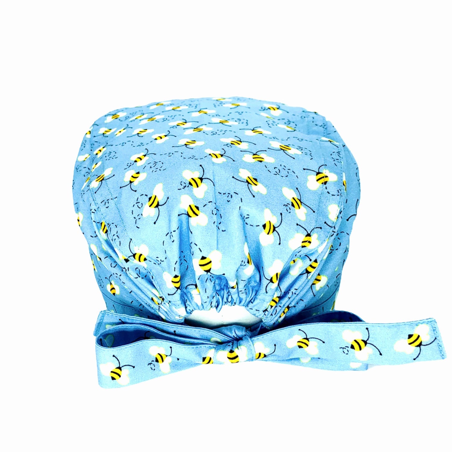 Immagine retro di cuffia medica con laccio ed elastico anche per capelli lunghi. Su fondo azzurro tante delicate api svolazzanti stampate.