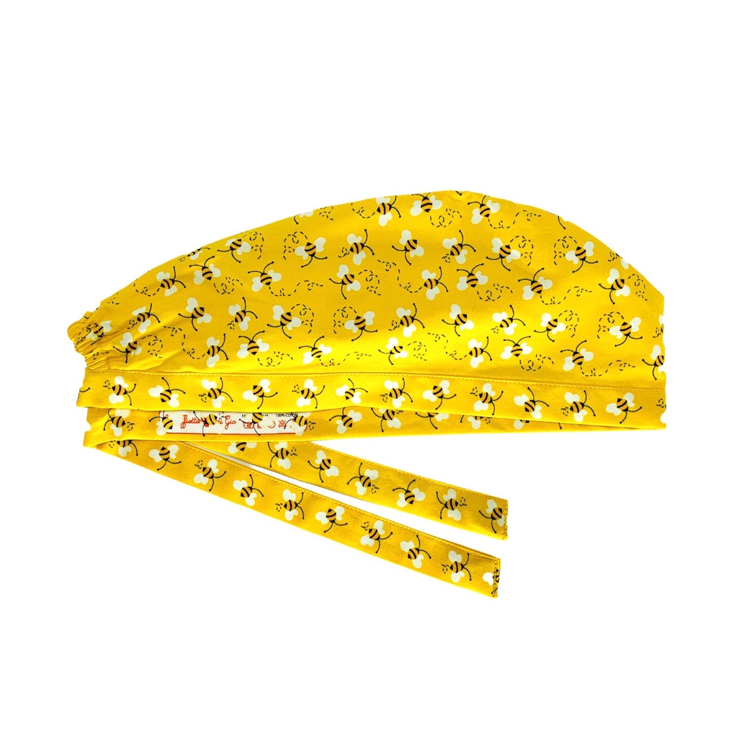 Immagine laterale di cuffia medica stirata con stampa etichetta, le cuffiette di gio, su lato interno del laccio. Su fondo azzurro tante delicate api svolazzanti stampate.