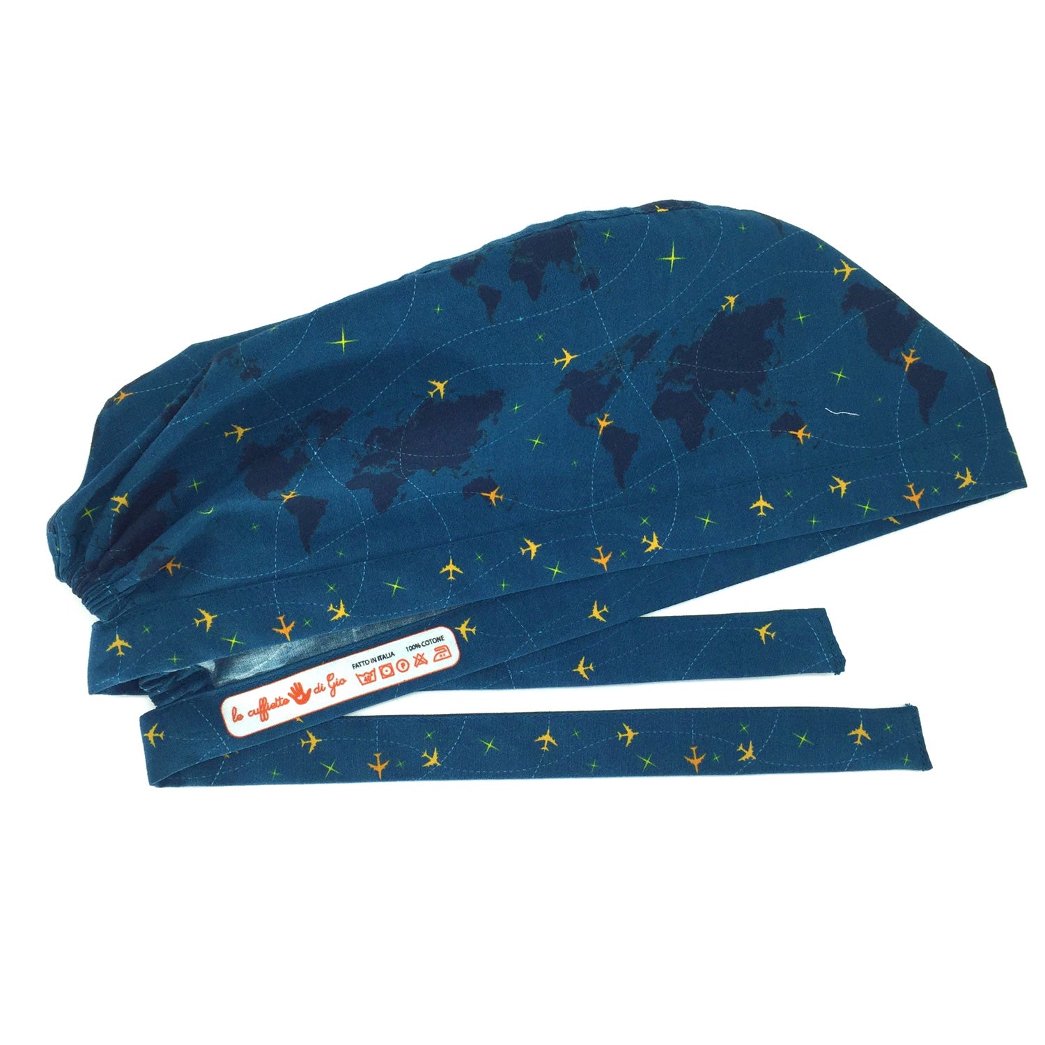 Cuffietta chirurgica con mappamondo e piccoli aerei gialli che tracciano delle linee tratteggiate, sfondo blu avio