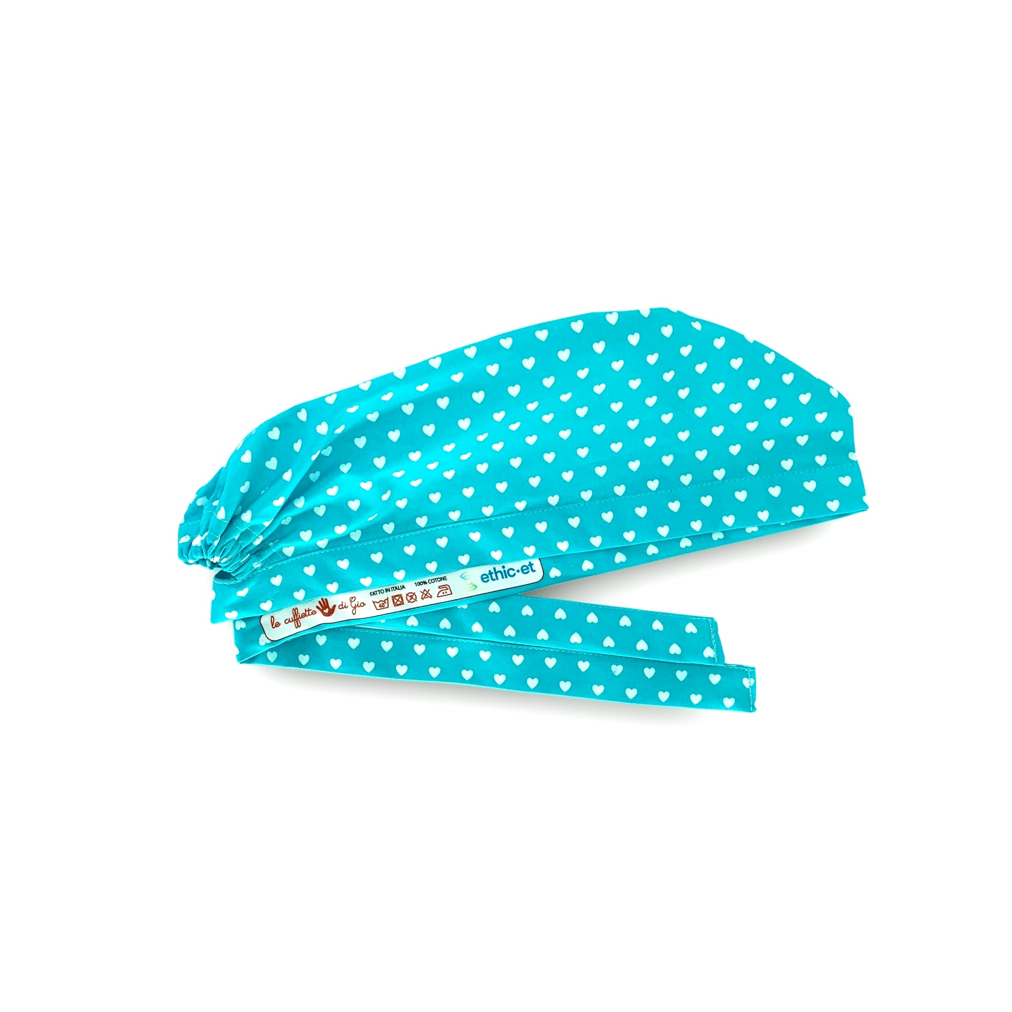 Piccoli cuoricini come pois su base tinta unita.
Cuori bianchi su turchese. Semplice ed elegante.