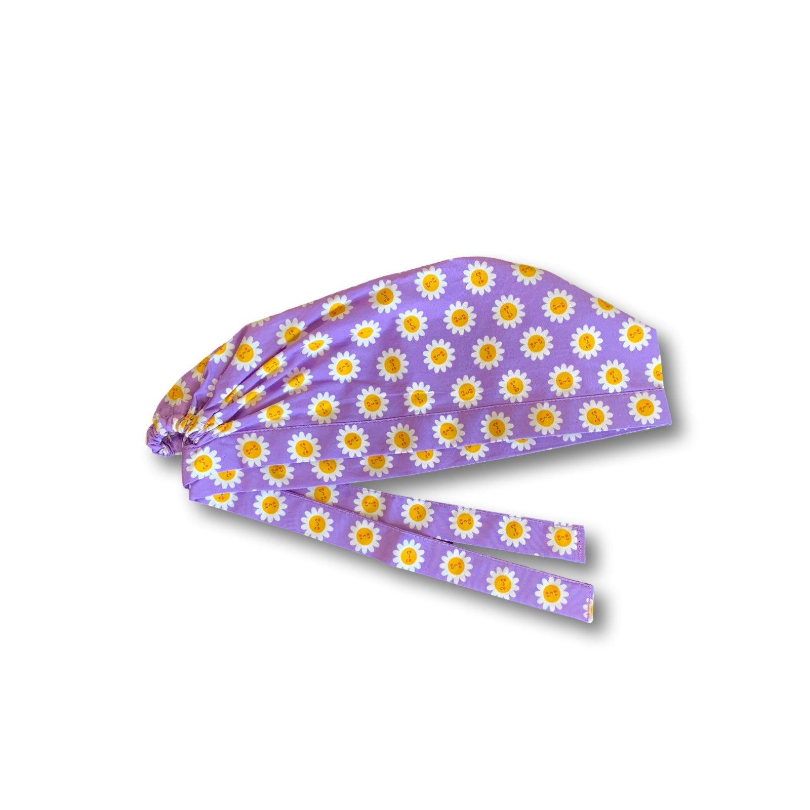 La bellezza di questa cuffietta chirurgica sta nella sua semplicità e nell'esplosività dei colori: piccole margherite con faccine sorridenti su sfondo lilla o turchese.