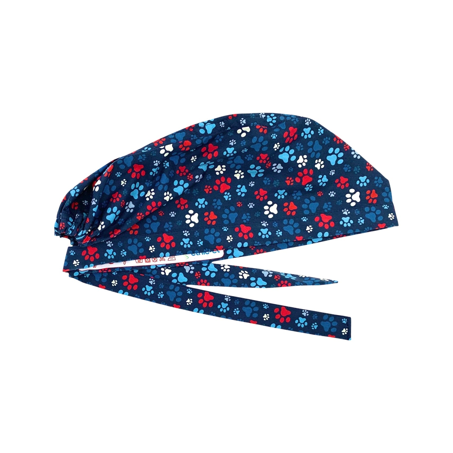 L'orma di una zampa di cane o gatto declinata in varie dimensioni e colori su base blu delinea un pattern semplice, vivace ed elegante al tempo stesso.
