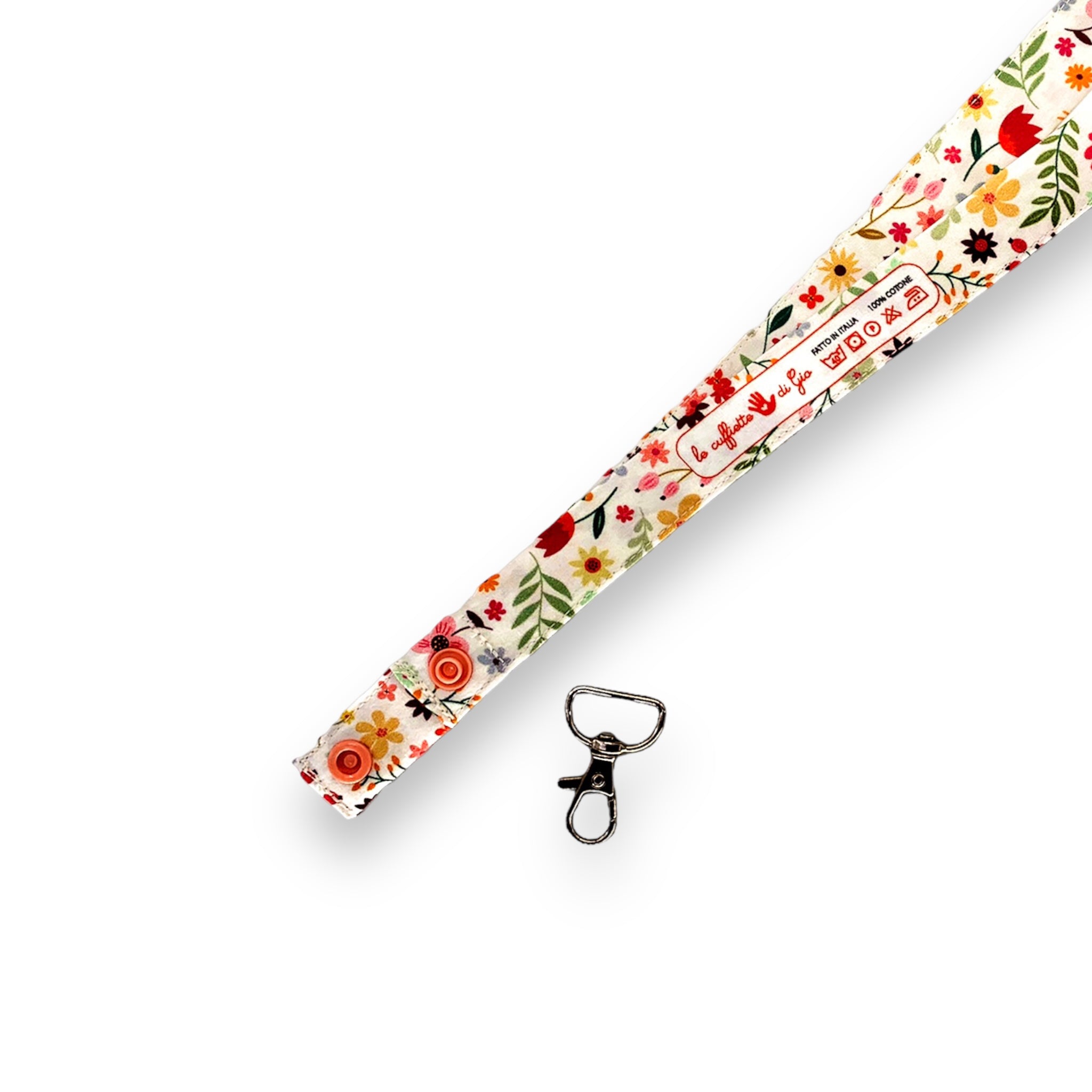 Una fascetta in cotone lunga 45 cm con fantasia floreale, dettaglio del moschettone separabile