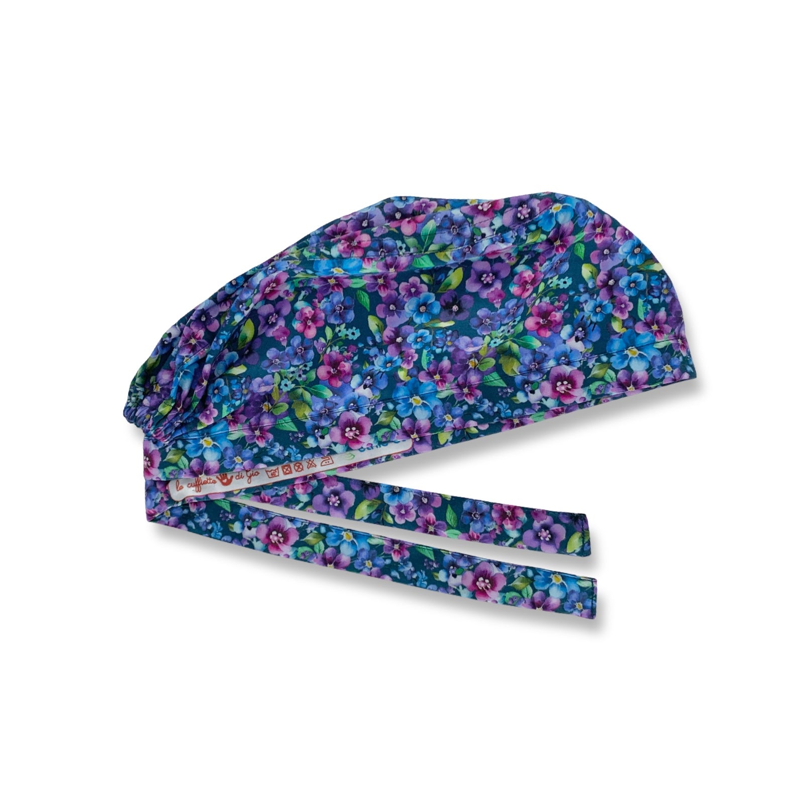 Una distesa di pansé dalle mille tonalità di viola, rosa e azzurro intenso, su sfondo blu avio. Una cuffietta chirurgica immancabile per chi ama i temi floreali e le tonalità vivaci.