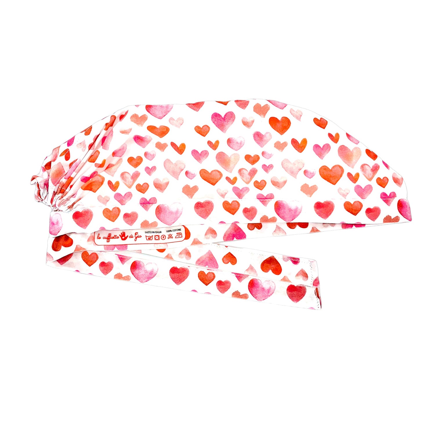 Cuffietta chirurgica con tanti cuoricini dipinti sui toni caldi del rosa e dell'arancio su base bianca