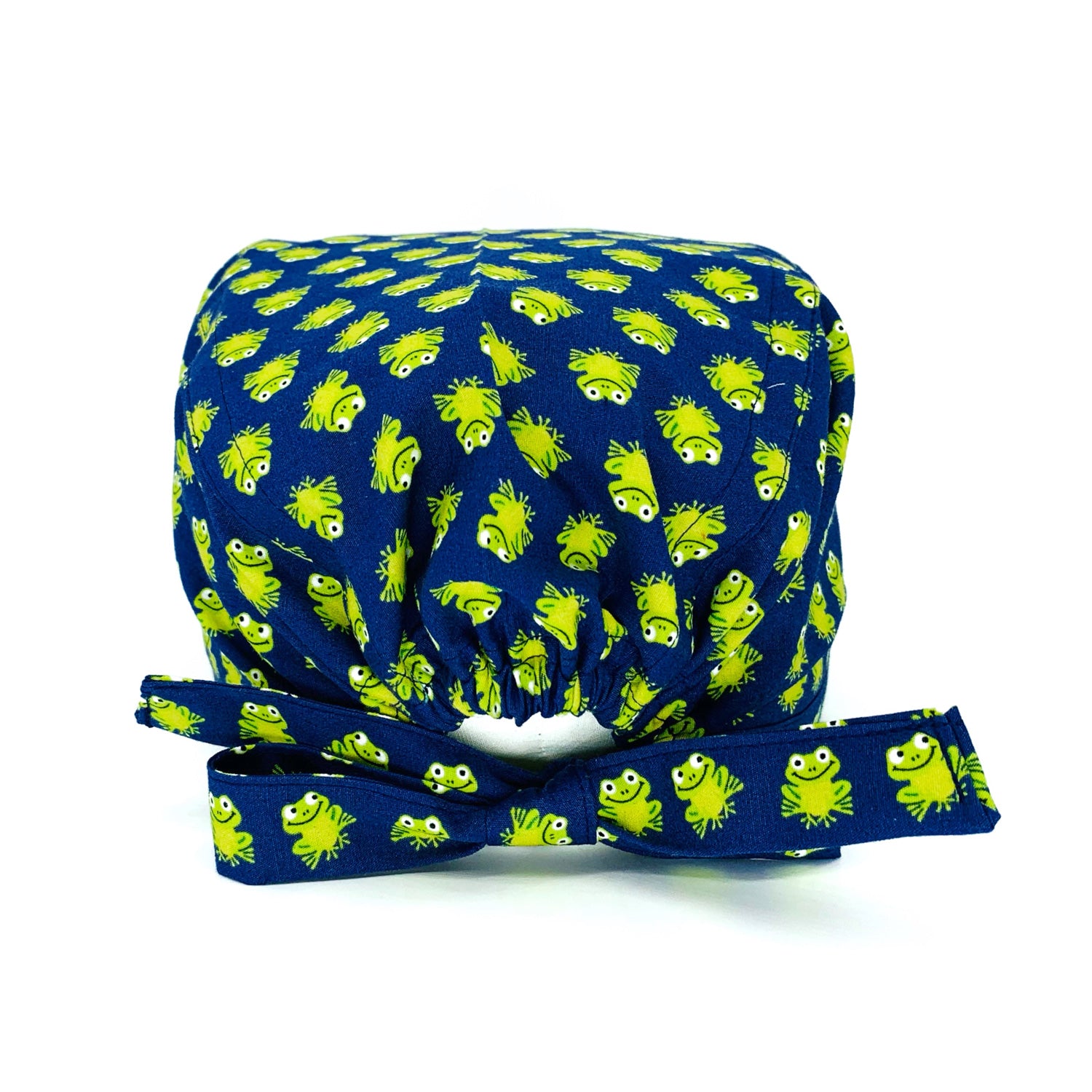 Cuffietta chirurgica con tante piccole ranocchie verde acido su sfondo blu, un pattern semplice e una combinazione di colori energizzante